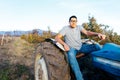 Front view of a latin farmer man driving an old tractor, in the middle of his farmland at sunset Royalty Free Stock Photo