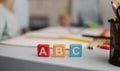 front view letters cubes with defocused tutoring session back. High quality beautiful photo concept