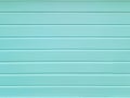 Front view of light blue horizontal scratched plaster. Light blue rough texture of cement wall. Light green wall with horizontal Royalty Free Stock Photo