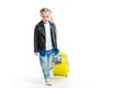 Front view of little child carrying yellow wheel suitcase