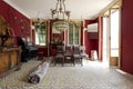 Front view of living room with leather chairs, rugs and red walls