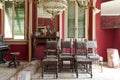 Front view of living room with leather chairs, rugs and red walls