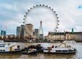 Front view of the London Eye and the County Hall on the banks of the Thames river, London