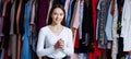 Front view look forward happy look holding hands crossed fingers young teen girl in clothing store.