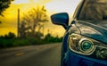 Front view of luxury blue compact SUV car with sport and modern design parked on asphalt road at sunset. Hybrid auto Royalty Free Stock Photo