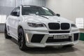 Front view of luxury very expensive new white BMW X6 M Lumma CLR tuning car stands in the washing box waiting for repair in auto