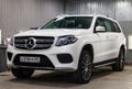 Front view of luxury very expensive new white Mercedes-Benz GLS 350d car stands in the washing box waiting for repair in auto