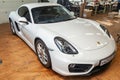 Front view of luxury very expensive new white Porsche Cayman coupe sportcar stands in the detailing box waiting for repair in auto