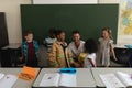 Front view of male firefighter teaching schoolkids about fire safety in classroom