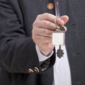 Front view of male hand with blank door keychain