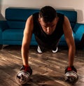 Front view of a man doing plank with dumbbells Royalty Free Stock Photo