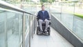 Front view of a man on electric wheelchair driving on a street. Accessibility concept Royalty Free Stock Photo