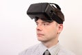Front view of a man wearing a VR Virtual reality Oculus Rift 3D headset, face looking left