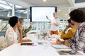 Businesswoman giving presentation on screen during meeting in a modern office Royalty Free Stock Photo