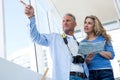 Front view of mature couple holding map Royalty Free Stock Photo