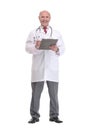 Front view of mature serious doctor writing on clipboard Royalty Free Stock Photo
