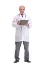 Front view of mature serious doctor writing on clipboard Royalty Free Stock Photo