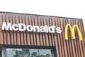 front view of the Mc Donald\'s fast food restaurant building with a big sign