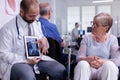 Front view of medical physician discussing with handicapped disabled senior woman Royalty Free Stock Photo