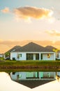 Early morning, light, with house reflected, on small lake Royalty Free Stock Photo