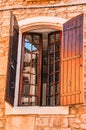 Pair of brown, wood, window shutters, on a 1300`s century stone and mortar building