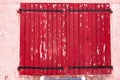 Closed, pair of, peeling red painted, wood, window shutters