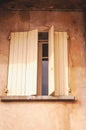 Slightly open, pair of, colorful, yellow, wood, window shutters, Seguret, France