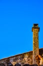 Tall concrete, chimny with a flat metal top,on side of a building in a village in Provence, Francd