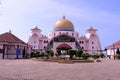 Front view of Melaka Straits Mosque, located on the man-made Malacca Island, which appears floating on the sea when there is a Royalty Free Stock Photo