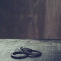 Front view of metal handcuffs on table in the interrogation room Royalty Free Stock Photo