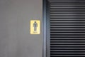 Front view of metallic sign indicating men on dark concrete cement wall shows labelling lavatory or toilet for male which seeing