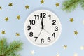 front view midnight clock with golden stars pine leaves. High quality photo