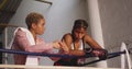 Two mixed race women discussing in boxing ring