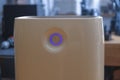 Front view of modern air purifier with glowing purple air quality indicator ring in contemporary home setting Royalty Free Stock Photo