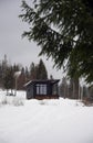 Front view of a Modern black tiny cabin on snowy mountains Royalty Free Stock Photo