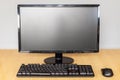 Front view of a Modern Desktop Computer Setup with Monitor, Keyboard, and Mouse on a Desk