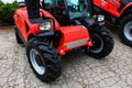 Front view of modern french compact agricultural telehandler vehicle Manitou MLT 625, red color