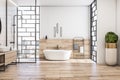 Front view on modern interior design of light bathroom with city view from stylish windows, white bath, wooden floor and sink base Royalty Free Stock Photo