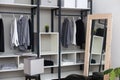 Front view of modern and large wardrobe in dressing room with fashionable woman clothes wear Royalty Free Stock Photo