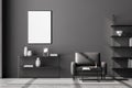 Front view of modern living room interior with one empty poster on dark grey wall, mock up. Furnished by black armchair, coffee Royalty Free Stock Photo