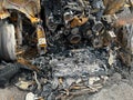 Burnt out car, burnt out car after accident. Engine block, front axle, tires. Royalty Free Stock Photo