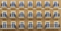 Front view of a modern residential brown brick building with balconies and Windows, close-up, pattern Royalty Free Stock Photo