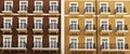 Front view of a modern residential brown brick building with balconies and Windows, close-up, pattern Royalty Free Stock Photo