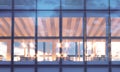 Front view of modern skyscraper. Modern office interior in evening time.Panoramic windows facade background Royalty Free Stock Photo