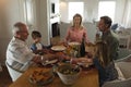 Family praying together before having meal on dining table Royalty Free Stock Photo