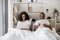 Multicultural couple using gadgets for work at home Royalty Free Stock Photo