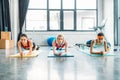 front view of multiethnic female athletes doing plank on fitness mats