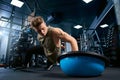 Bodybuilder doing push ups on one hand.