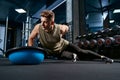 Bodybuilder doing push ups on one hand.