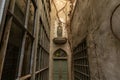 Front view of narrow alley entrance of ancient church with wooden door and stone woman statue Royalty Free Stock Photo